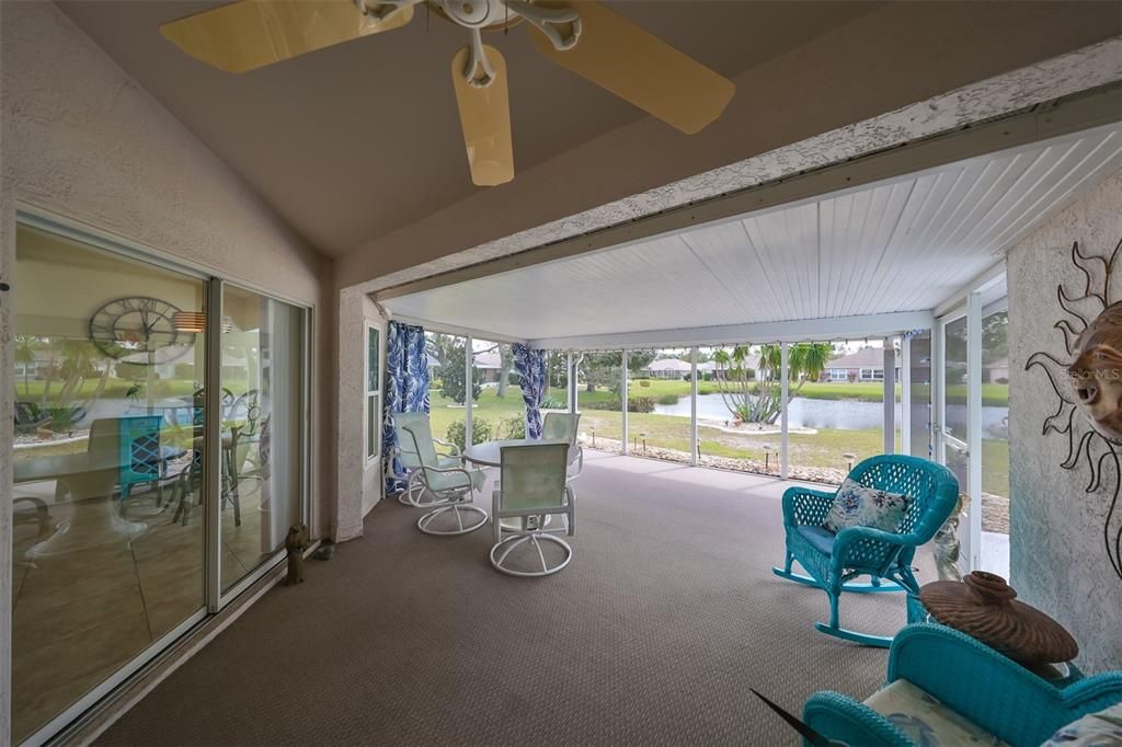 A large spacious lanai with water view and green space.