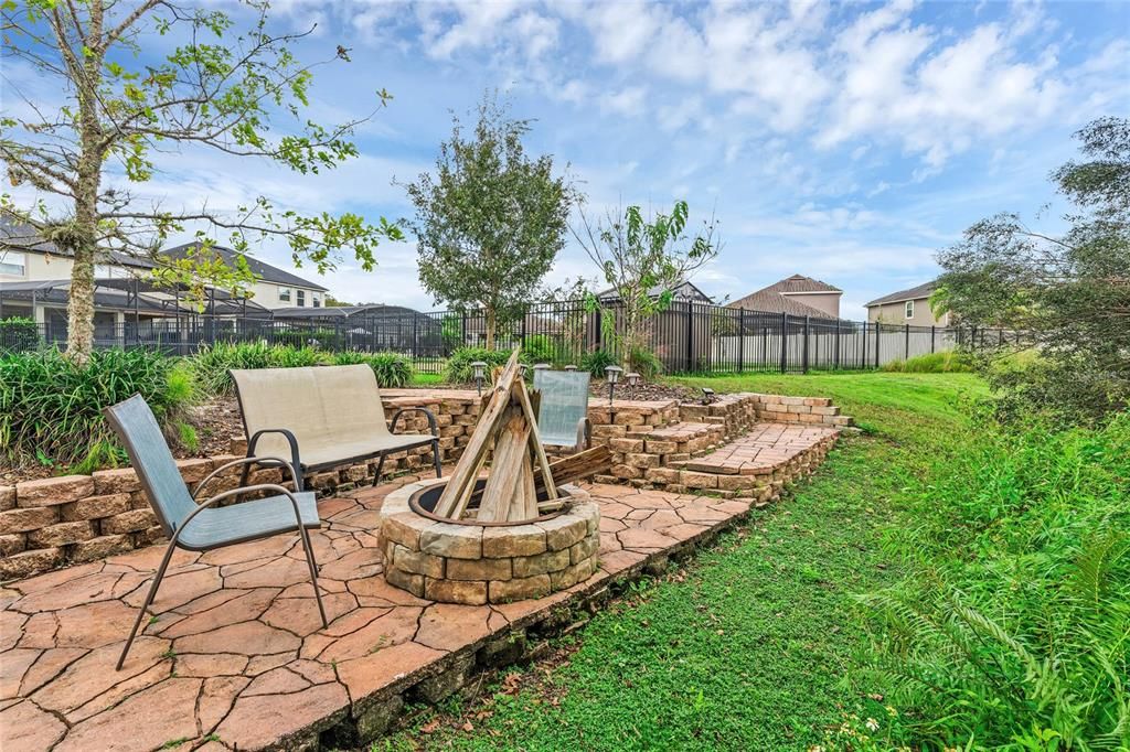 Also noteworthy; there is WHOLE HOME WATER FILTRATION, a French drain system and you will love the FIRE PIT and SEATING AREA at the very back of the property to relax and unwind or roast marshmallows all with the wooded view!