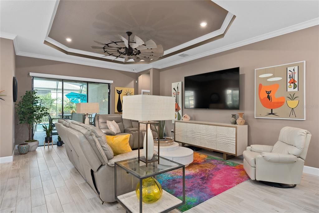 The Family Room with Tray Ceilings and Crown Molding. There is also additional lighting in the tray area and a Floor Electrical Receptacle.