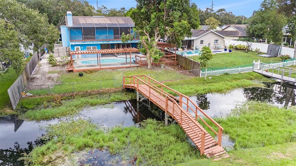 Backyard with bridge over retention pond