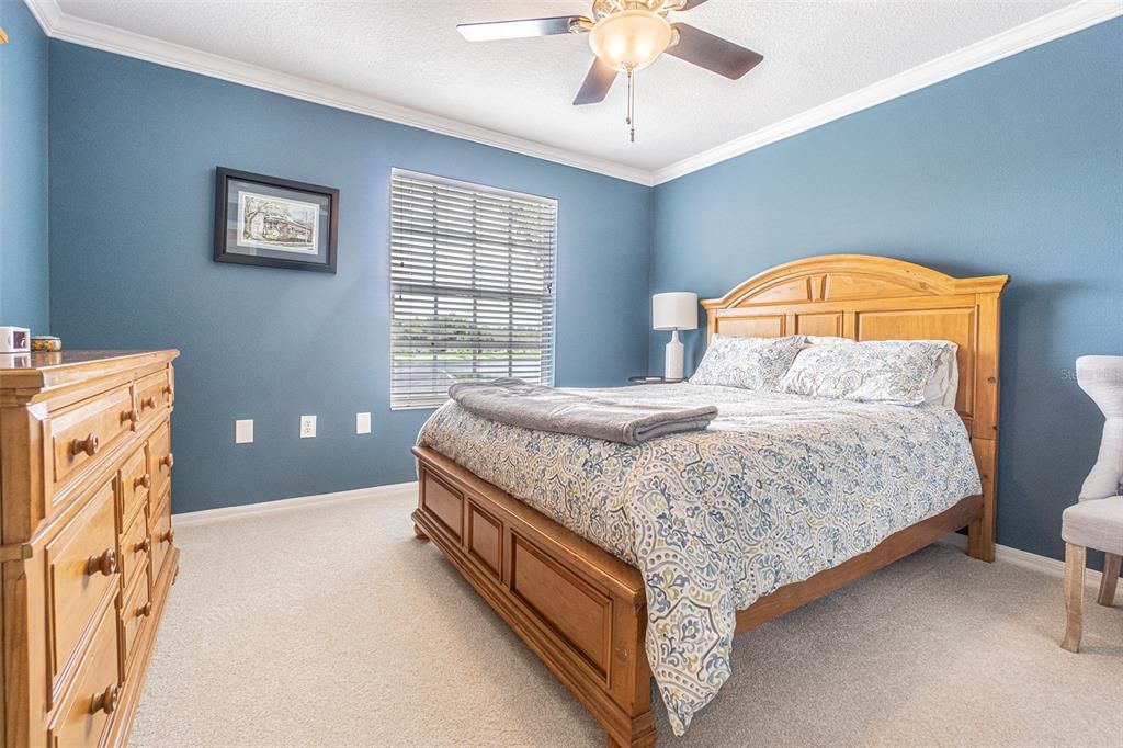 3rd bedroom overlooking the front of the home with dual built in closets and crown molding