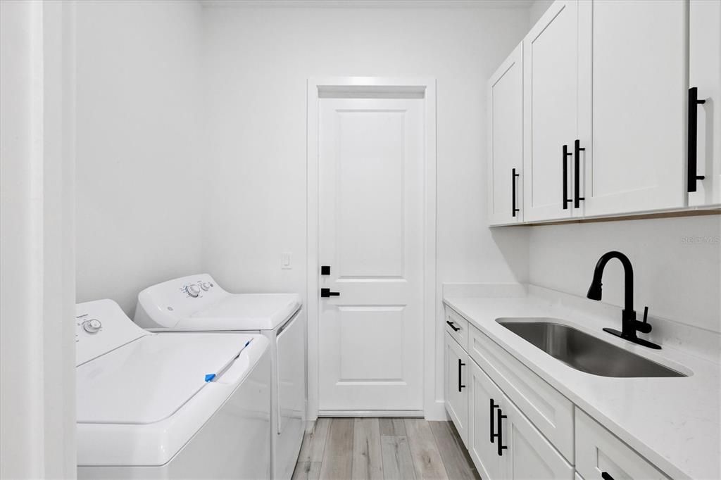 Spacious Laundry room with upgraded sink and lots of storage