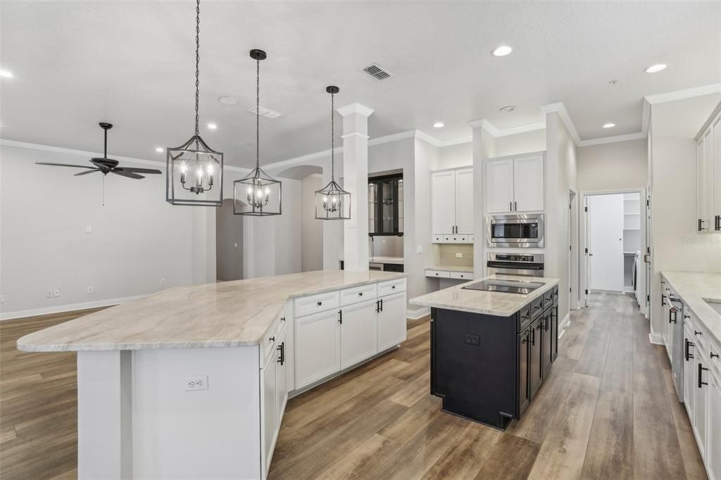 TWO TONE CABINETRY, a COOKING ISLAND and UPGRADED STAINLESS STEEL APPLIANCES await you in the gourmet kitchen along with GRANITE COUNTERS, a SUBWAY TILE BACKSPLASH and ample storage.