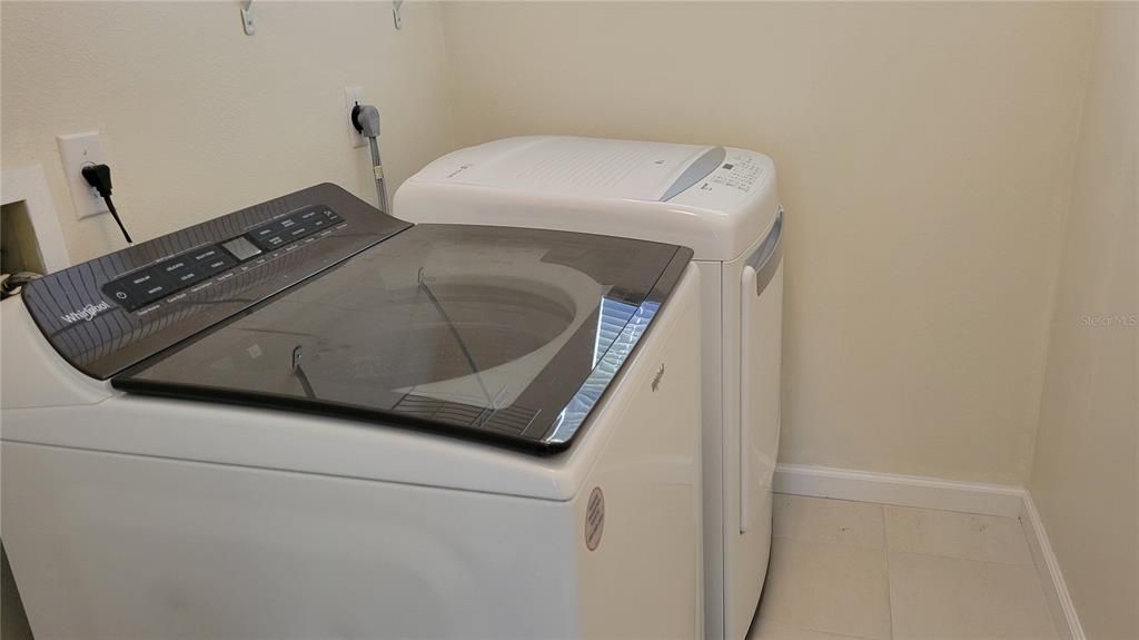 laundry room with sink and storage