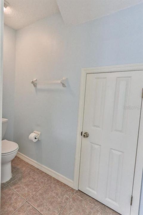 Water Closet w\ storage under stairs