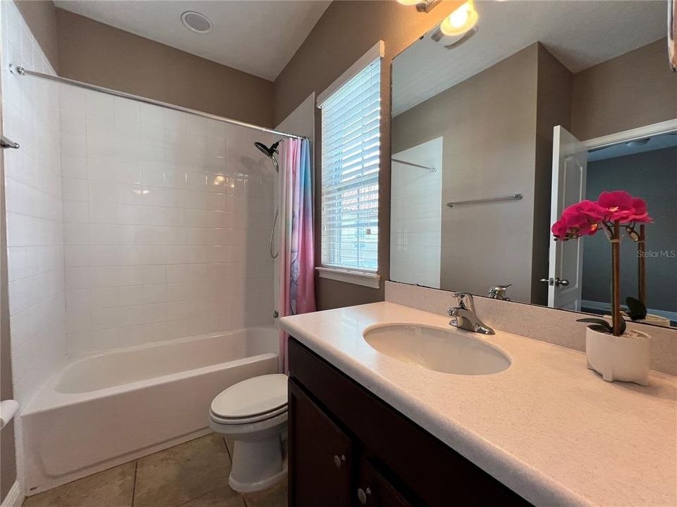 single sink vanity area, with a combination of tub and shower