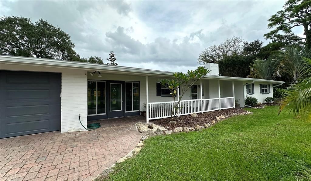 Concrete Block Home with Pavered Driveway and New Garage Door with Opener