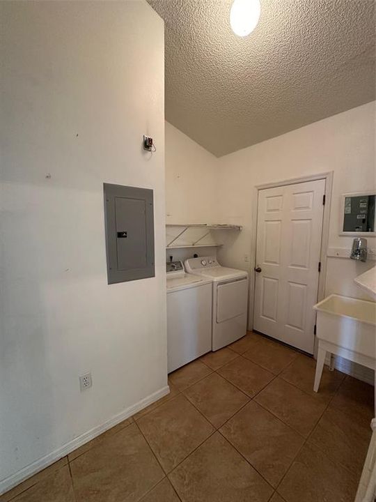 The three best features of this laundry room are 1) it's inside the home and 2) it has a wash tub, and 3) the washer and dryer are staying!