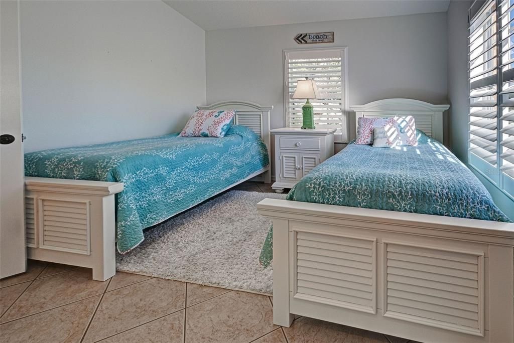 Ceramic tile floors and plantation shutters make the 2nd bedroom so special.