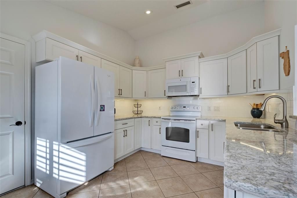 Beautifully remodeled kitchen is a knockout!  Gorgeous quartz countertops and so much storage space.