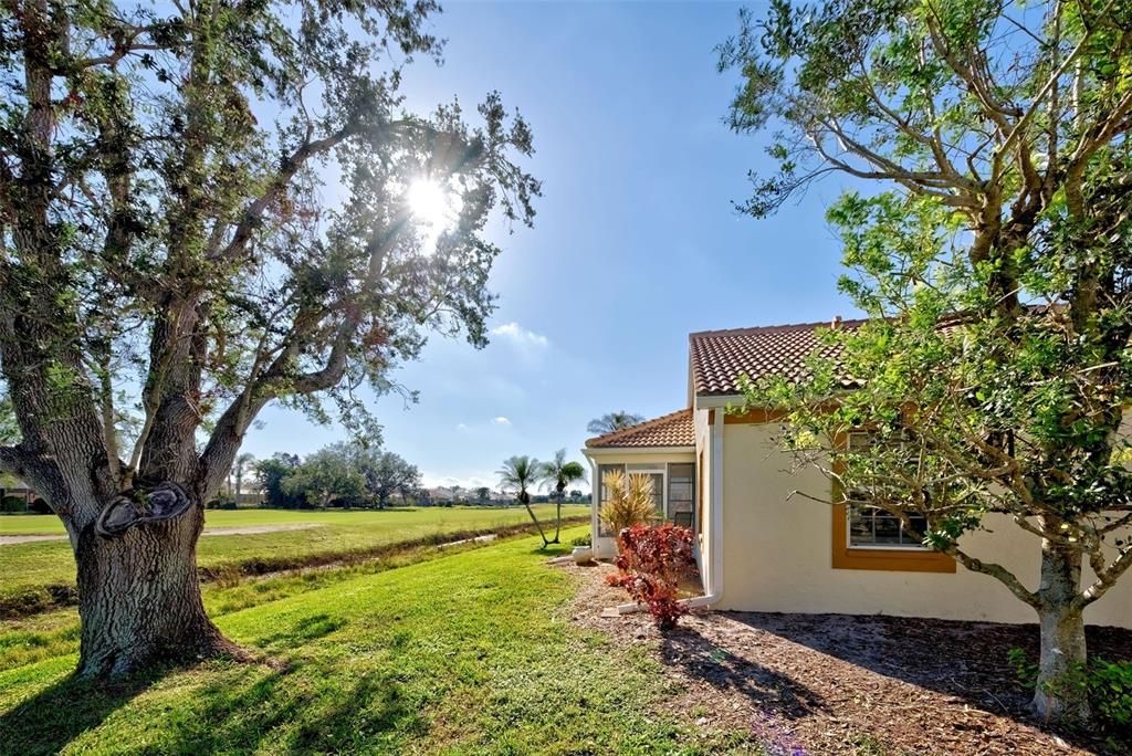 Side view of villa with mature, maintenance free landscaping.