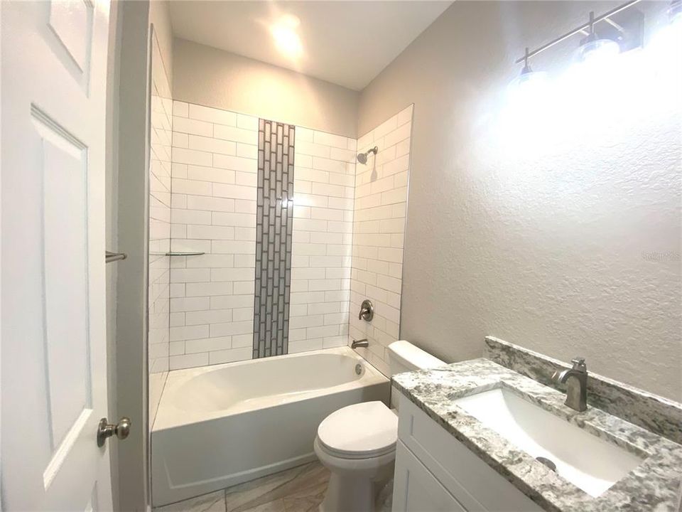 hall bath, granite vanity, tiled tub/shower combo