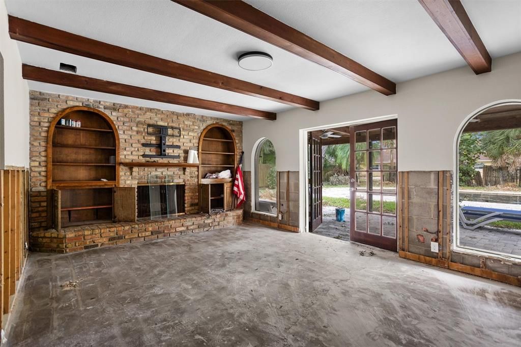 Cozy family room with fireplace--French doors to pool/ lanai