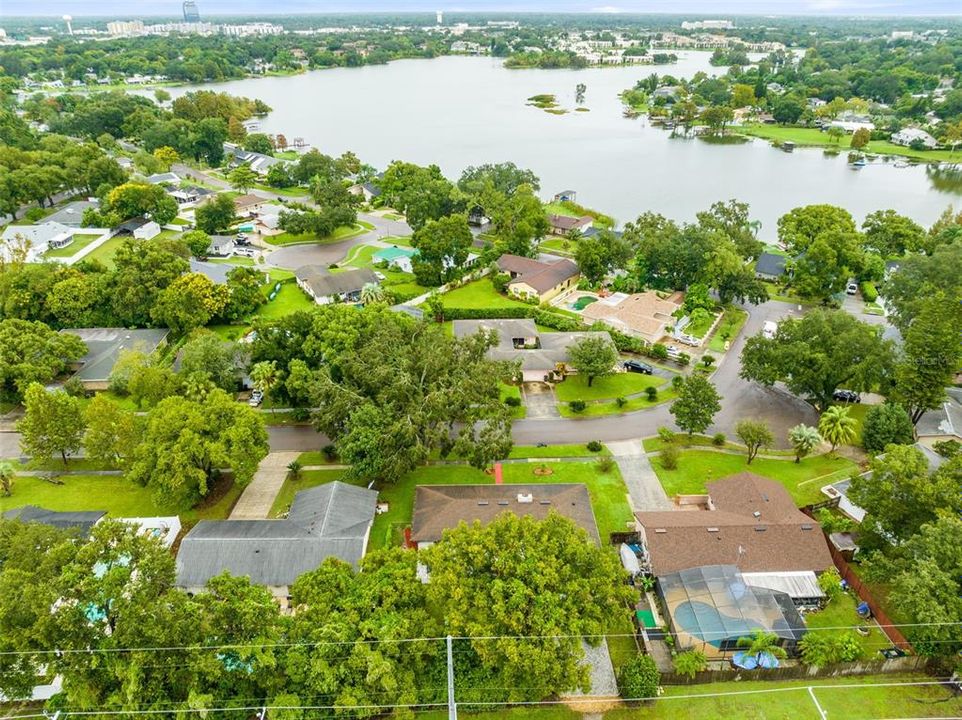 Aerial view of the rear of the home and surrounding neighborhood.