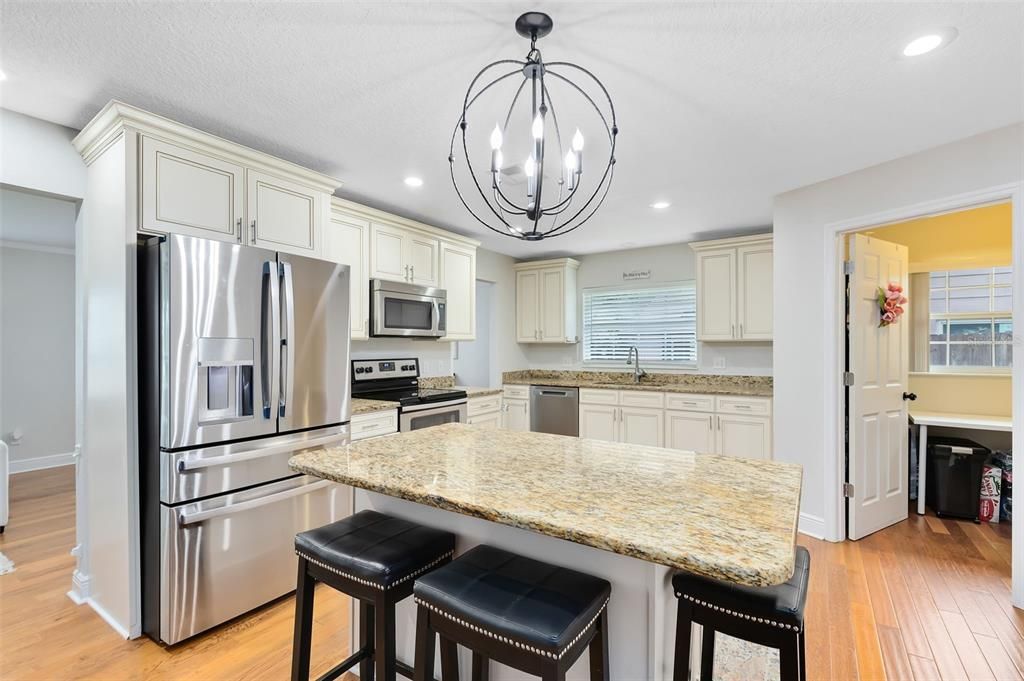 Your open kitchen features stunning granite countertops, a central island and stainless steel appliances.