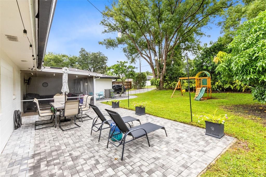 Step outside to the patio adorned with new pavers, overlooking a large, fenced backyard—ideal for entertaining or relaxing in privacy.