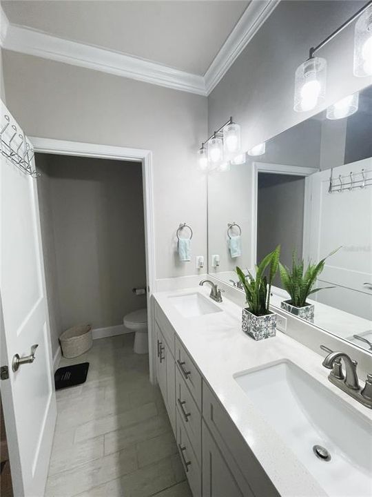 View of dual vanity sinks & Water closet