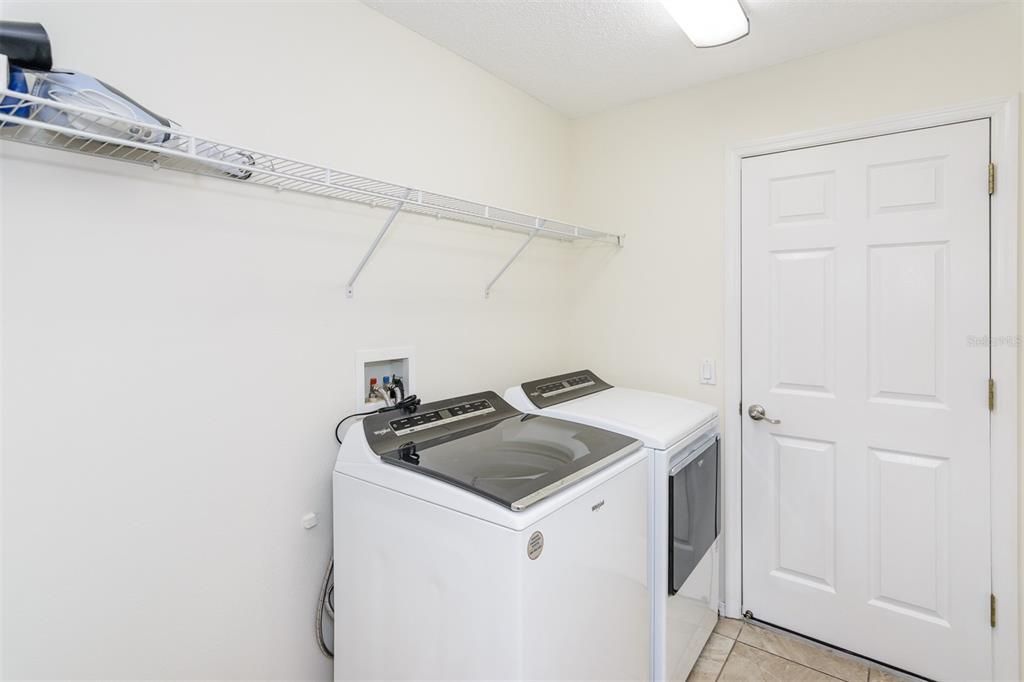 INSIDE LAUNDRY ROOM EQUIPPED WITH WASHER AND DRYER