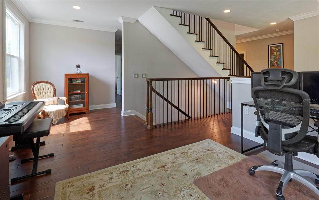 STAIRWAY IN CENTER OF HOME AS SEEN FROM THE LOFT AREA