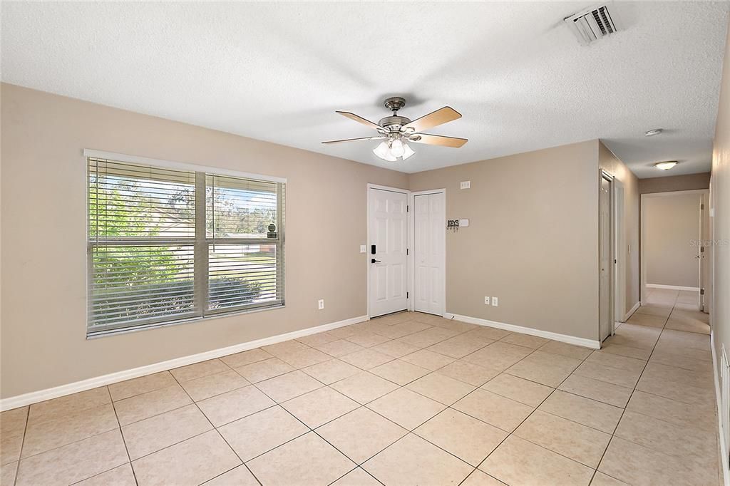 Living room from dining room; hallway to bedrooms to the right