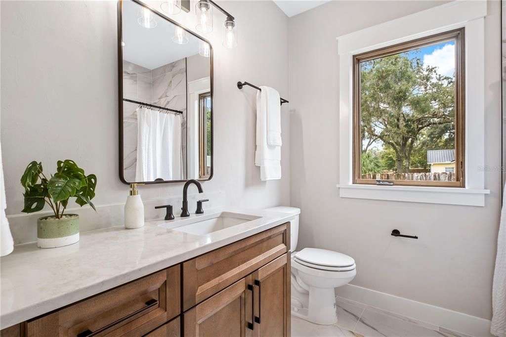 Bathroom II includes an open linen shelving area and tub.