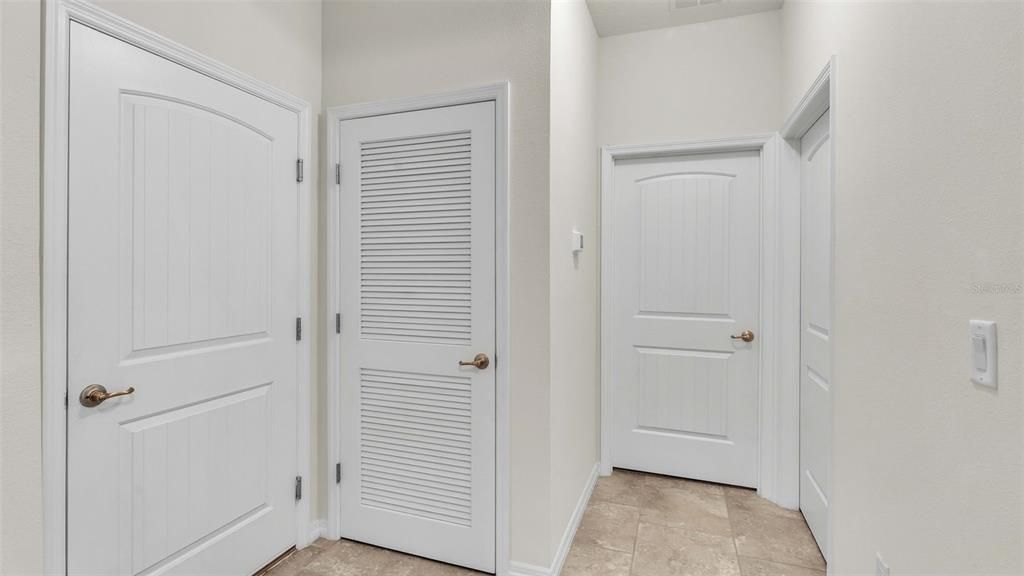 door to garage, laundry room and 4th bedroom