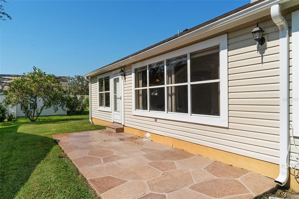 REAR EXTERIOR view shows 4 windows which provide abundant NATURAL LIGHT for the FLORIDA ROOM