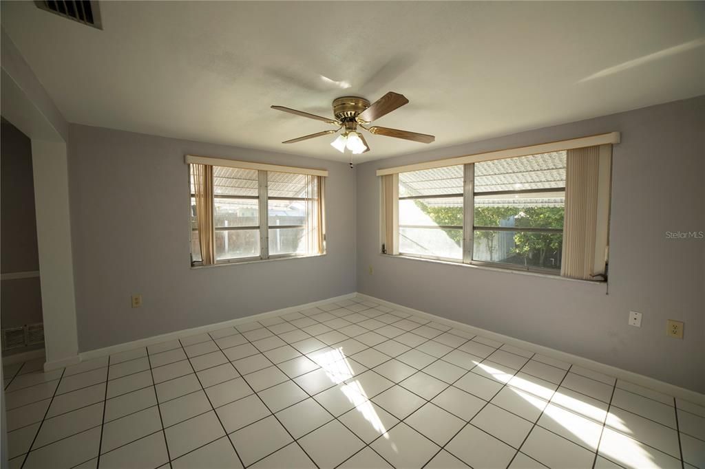 Family room looks onto back yard. You can see hurricane shutters through the windows