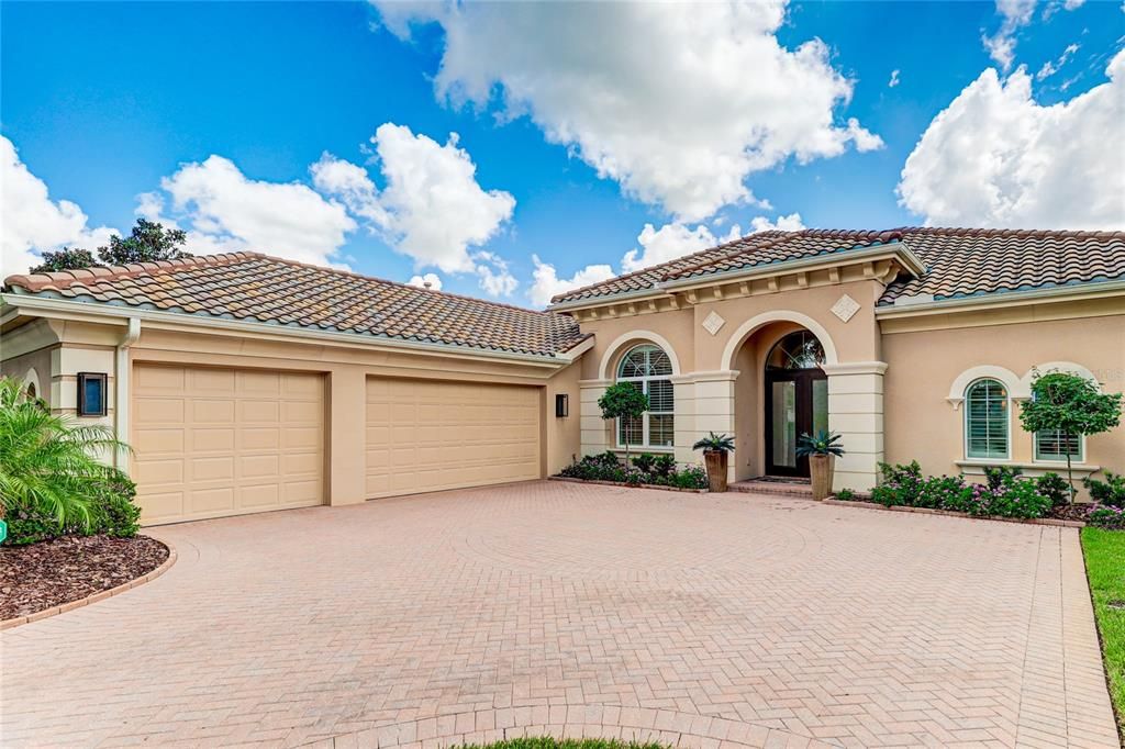 3 car garage and oversized paver driveway