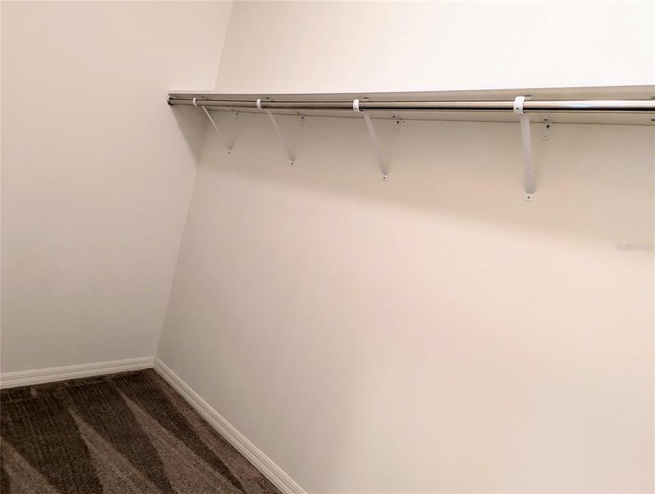 Primary walk-in closet with shelves