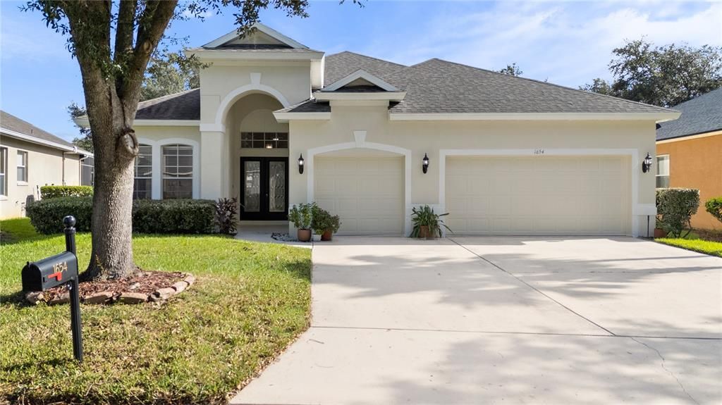 Beautiful curb appeal with large oak tree, double glass front doors and new exterior paint (2024)