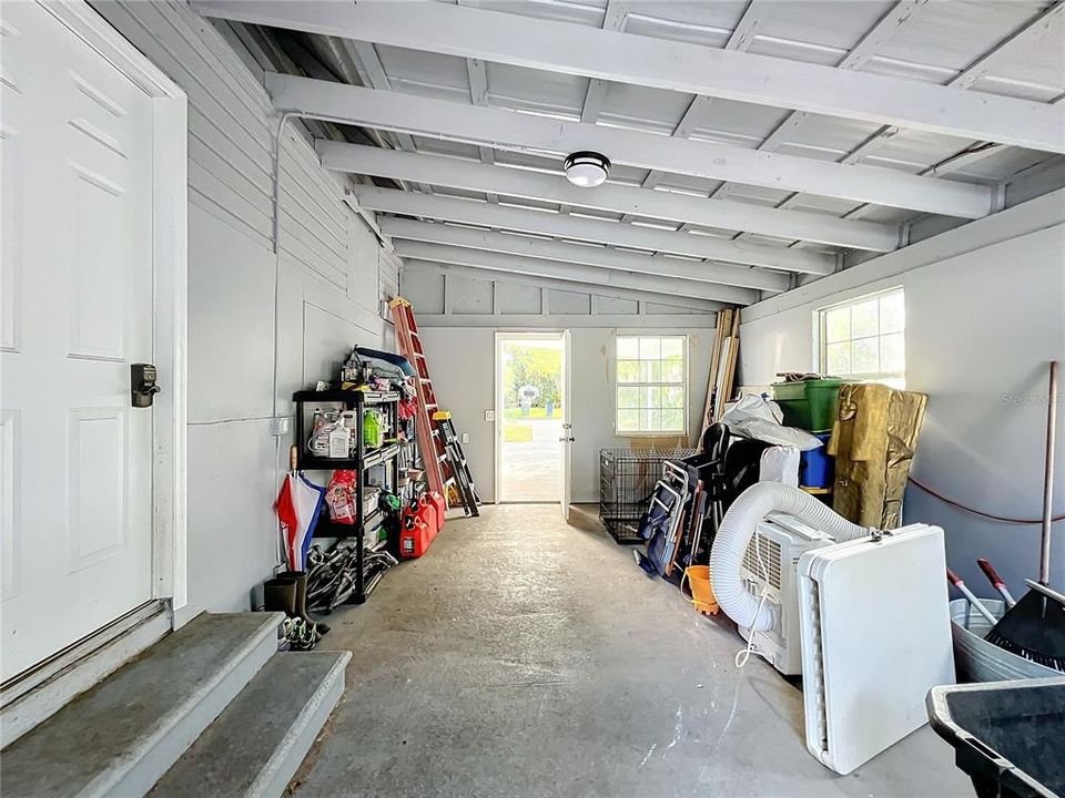 Storage area behind car port with entry into dining room