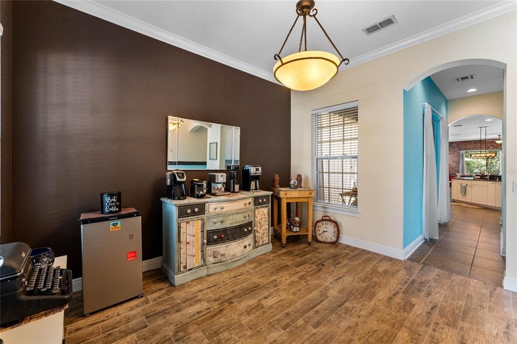 front den or dining leading through to kitchen with butler pantry and side screened patio