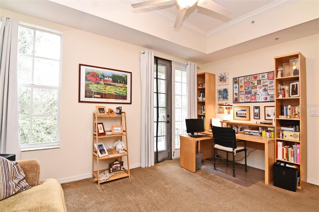 Primary Bedroom with window and balcony view