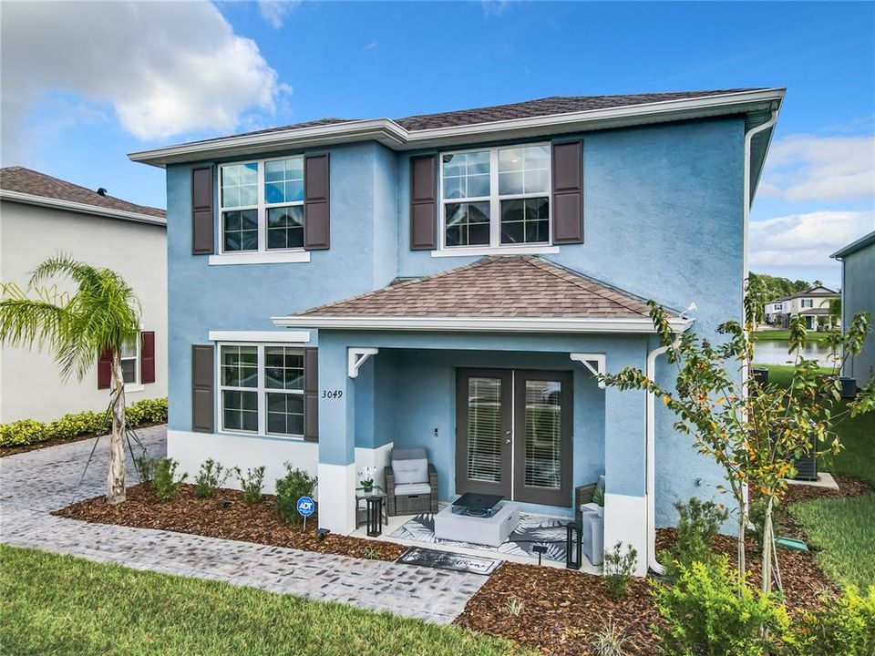 The beautiful 3049 Meleto Blvd with front porch, shutters, paver driveway