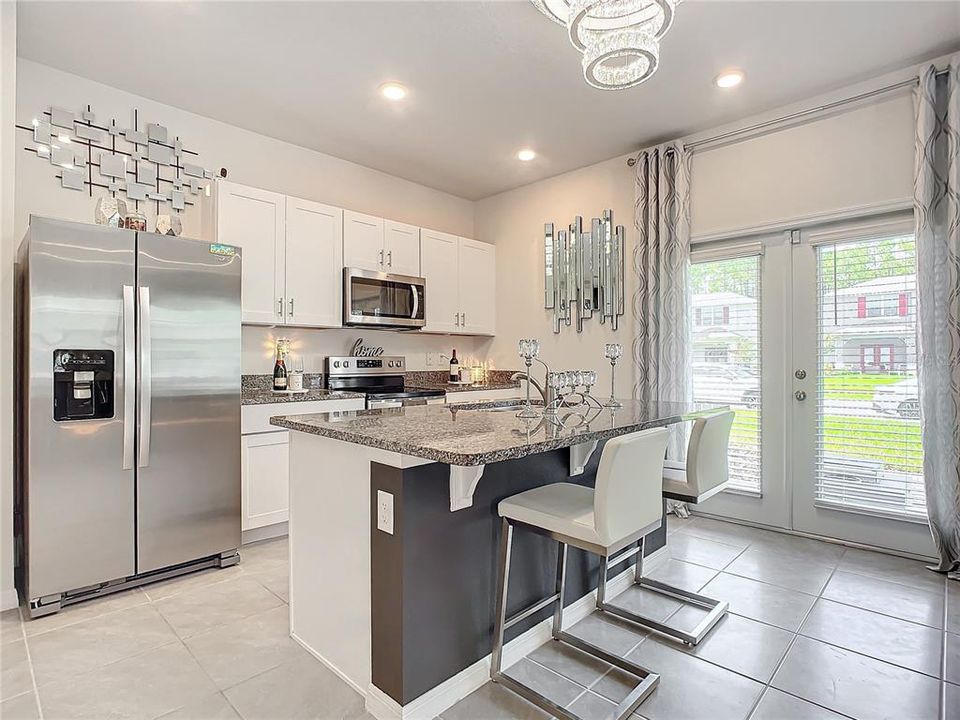 Kitchen with eat in kitchen space, french doors and granite counter tops