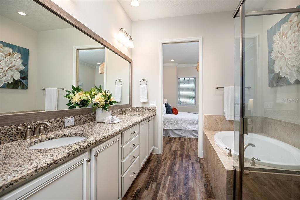 En-suite bath with an oversized double vanity, garden tub & separate shower