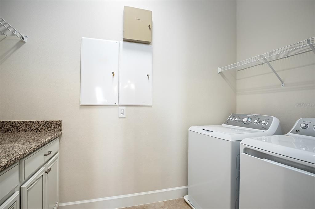 Inside utility room with a folding counter & storage space