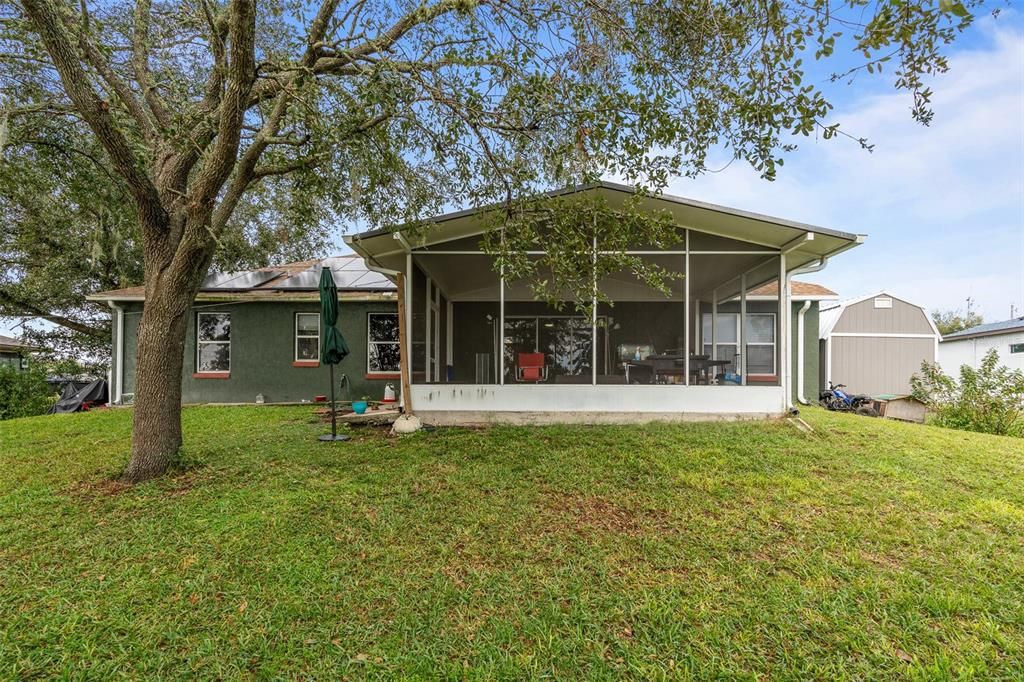 screened in rear patio with lake views and oversized backyard.