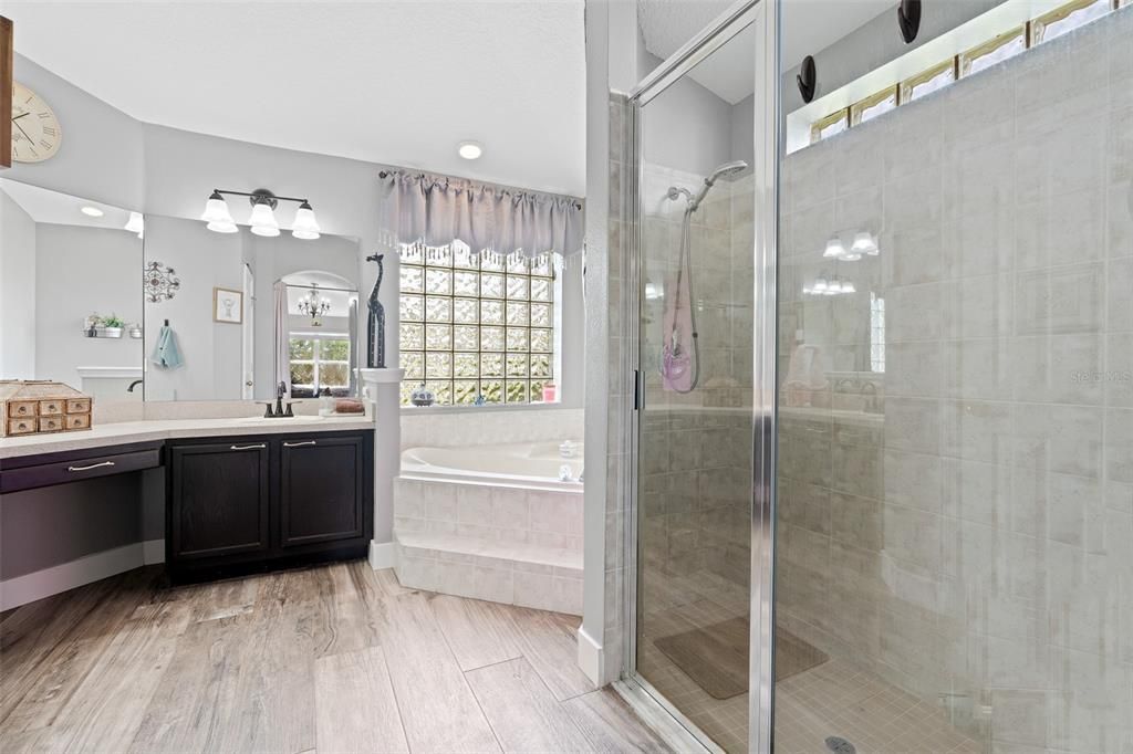 master bathroom with dual sinks, walk in shower and soaking tub.