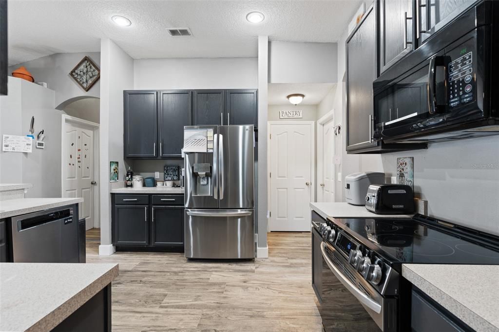 modern kitchen with stainless steel appliances and access to garage.