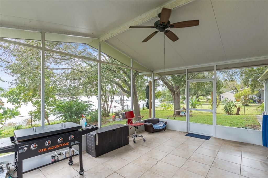 screened in rear patio with lake views and oversized backyard.