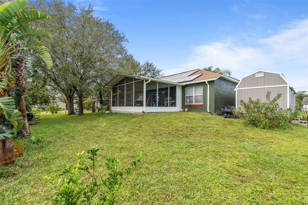 screened in rear patio with lake views and oversized backyard.