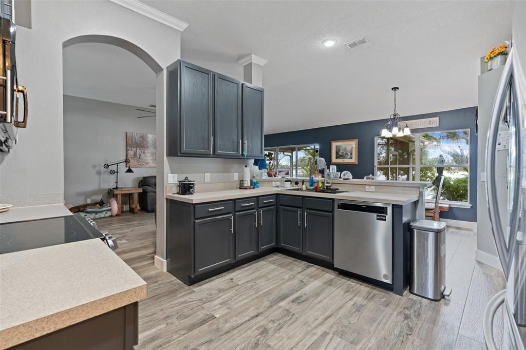 modern kitchen with stainless steel appliances and lake views.