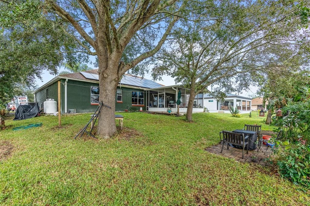 screened in rear patio with lake views and oversized backyard.