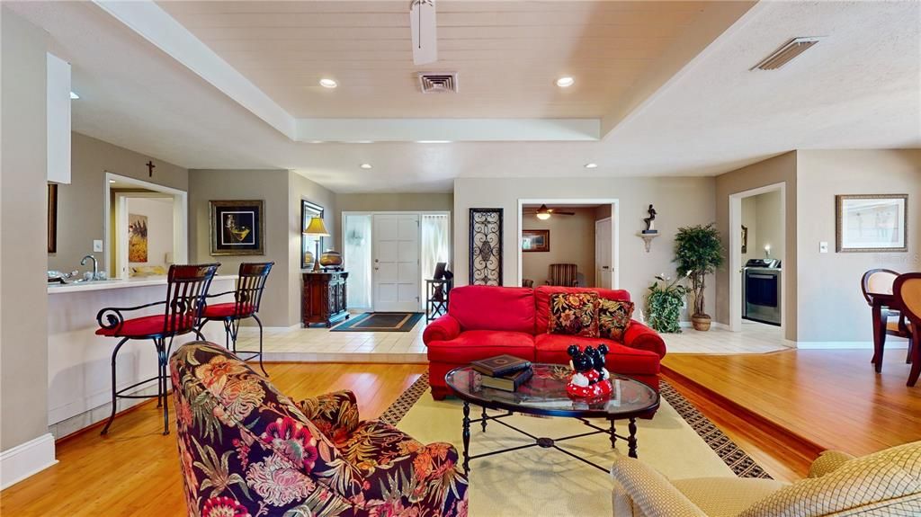 Formal living room looking back to the front door and wet bar on the left