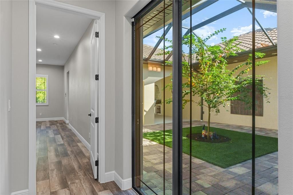 Hallway with doors to screened courtyard