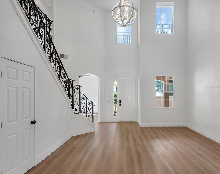 The Stunning Foyer with 20 foot Ceilings and Windows that Bathe the Room in Sunlight