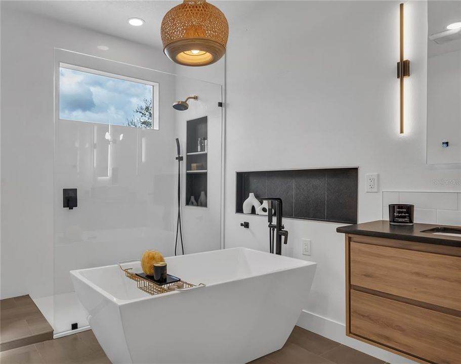 Floating Double Vanity with Flattering Back Lit Mirrors, a Niche and Waterfall Faucets