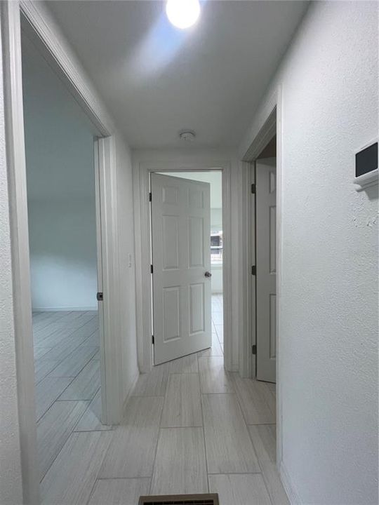 Hallway to second bathroom and both bedrooms.